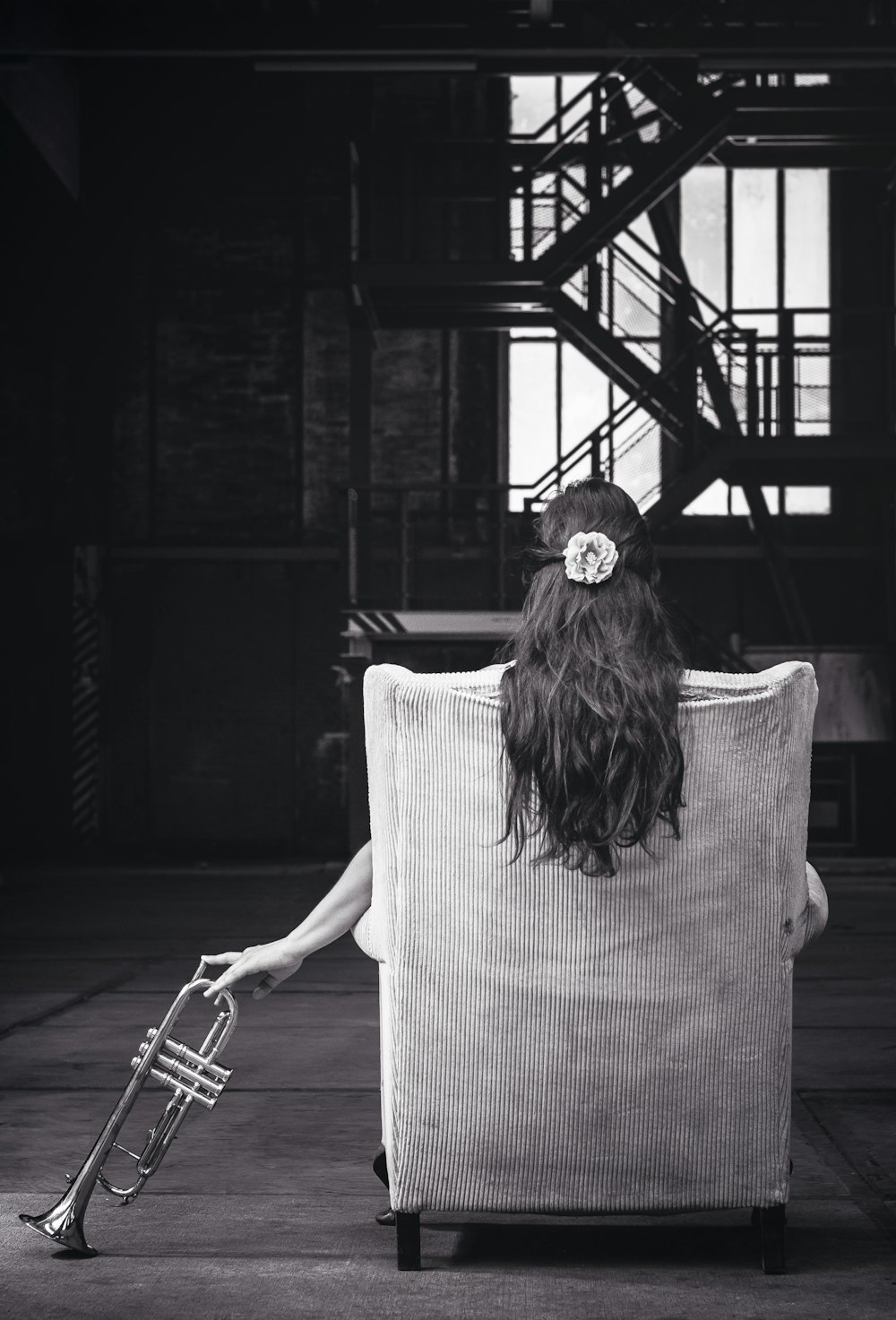 woman sitting on chair holding trumpet