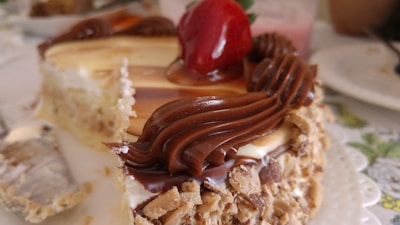 Close-up of a layered cake with fresh fruit topping and glossy glaze.