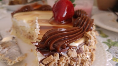 Close-up of a moist gluten-free cake slice topped with fresh berries and a drizzle of natural syrup.