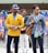 two man wearing yellow and grey suit jacket standing close together