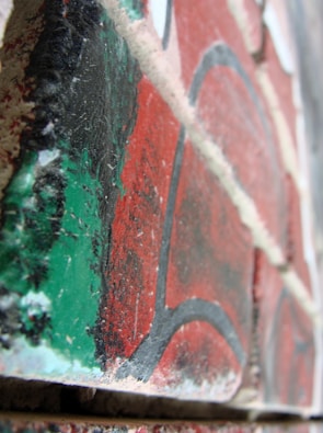 A close-up of a detailed floral mural painted on a brick surface.