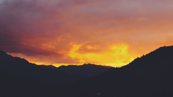 A vibrant sunset illuminating the mountains in the background.