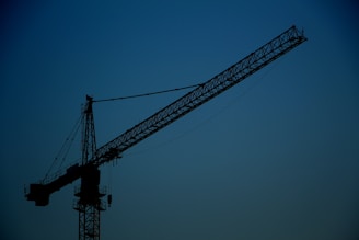 black metal crane tower under blue sky