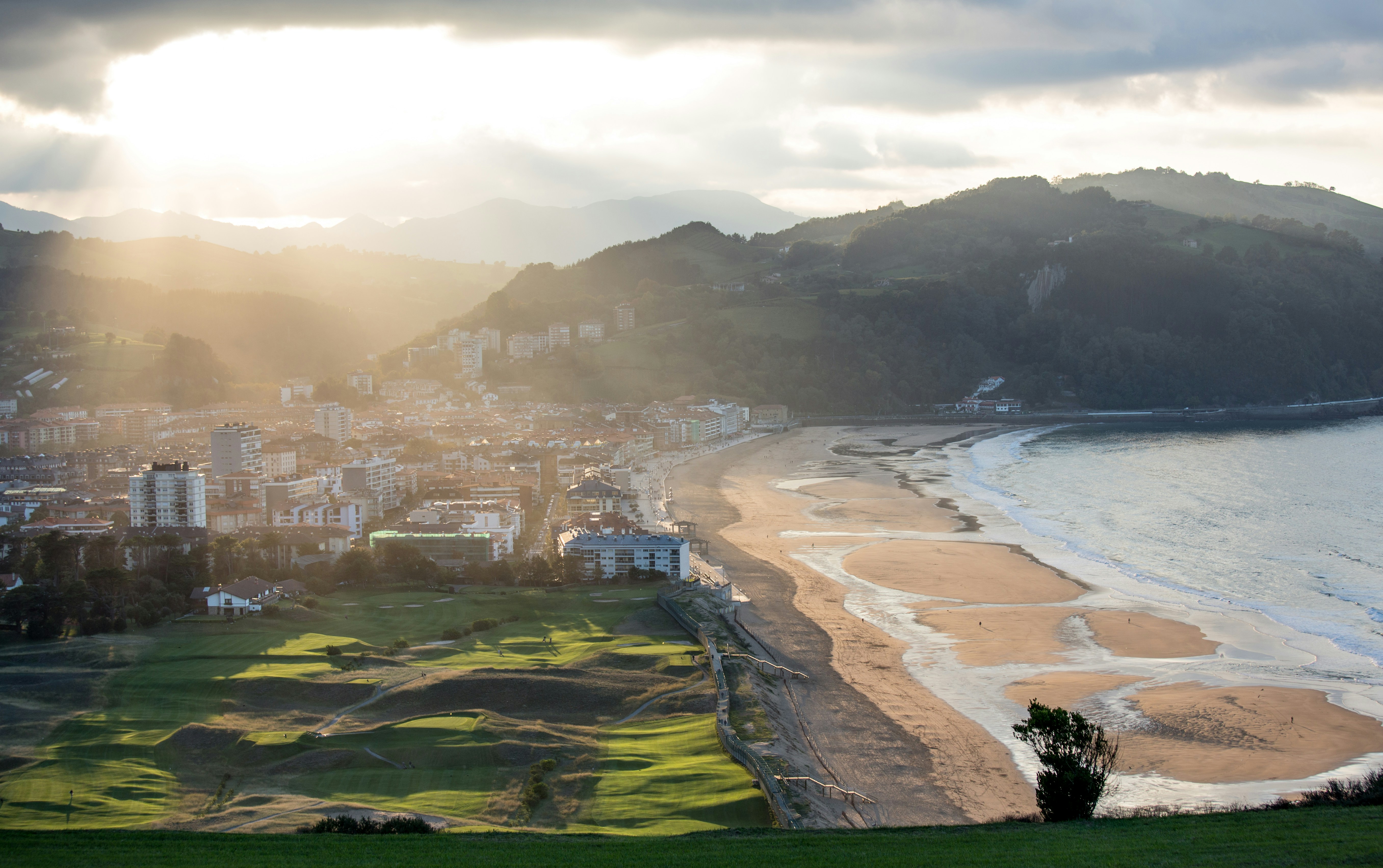 Aerial view featuring beach, settlements and surrounding landscape  of the mountains in countryside Zarautz