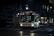 A city bus is captured during the night, illuminated by streetlights and its own interior lighting. The bus is on route 6A, heading to Bay and Dupont. The scene is set on a city street with minimal traffic and the urban landscape is partially visible with buildings in the background.