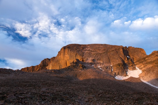 brown rock cliff under mid cloudy sky in Longs Peak, The Keyhole United States