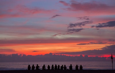 people sitting on seashore while watching golden hour reunion google meet background