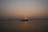 Couple enjoying a serene boat ride through Kerala’s lush backwaters at sunset