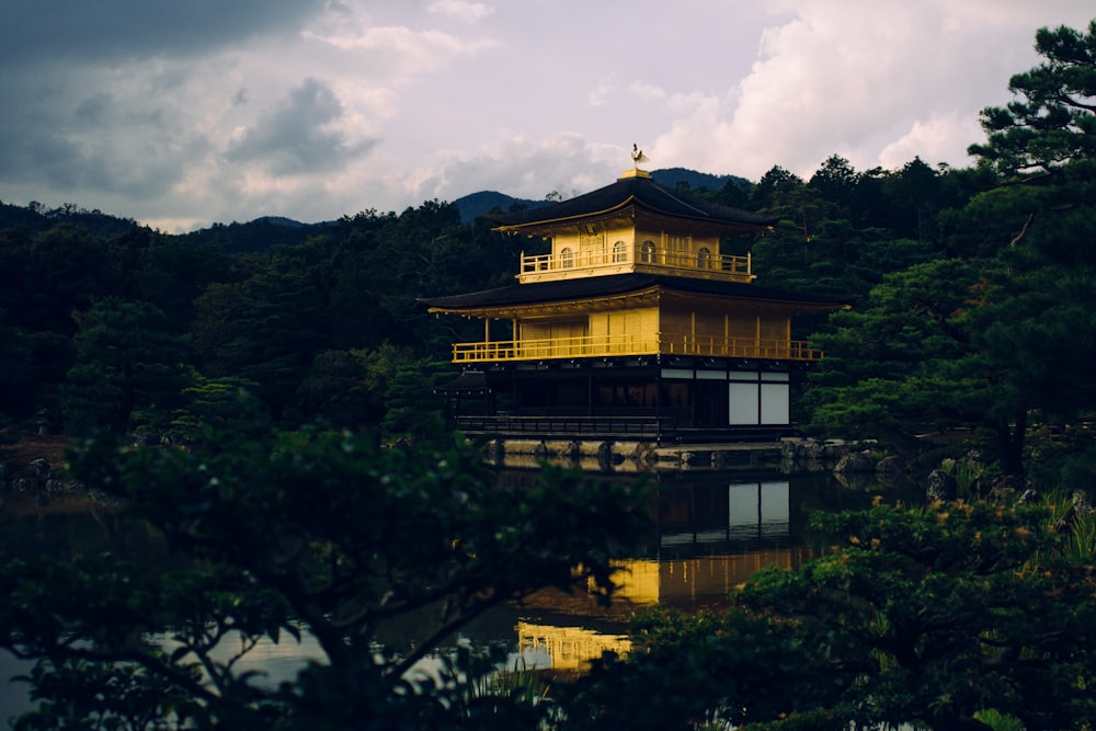 yellow and black pagoda near body of water