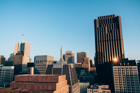 A sleek, modern office building skyline at sunset in Dubai, reflecting professional maintenance services.