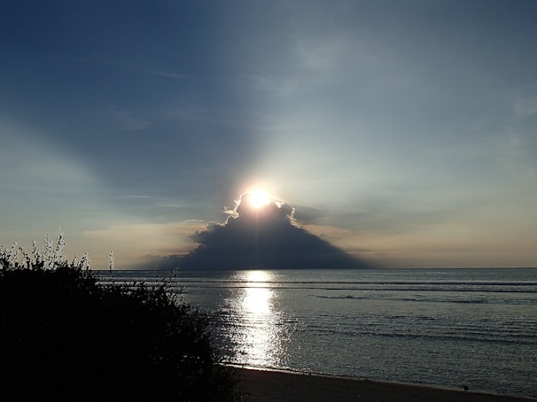 A soft-focus image of a sunrise over a calm sea symbolizing new beginnings.