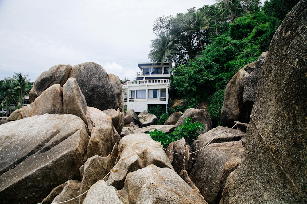architectural photography of house in the middle of rock formation