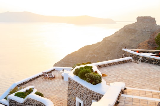 aerial photograph of building near body of water in Archipel de Santorin Greece