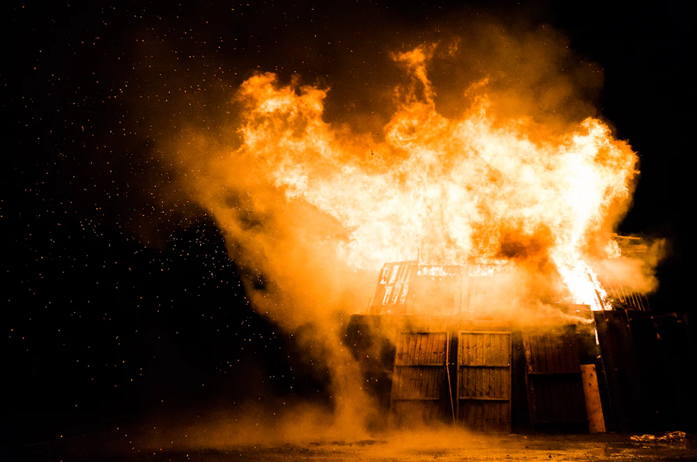 House engulfed in flames and smoke at night