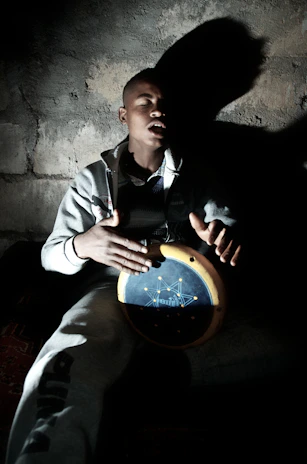 Jonah Goldheart performing live, eyes closed, deeply immersed in the music.