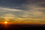 A scenic view of rolling hills at sunset.