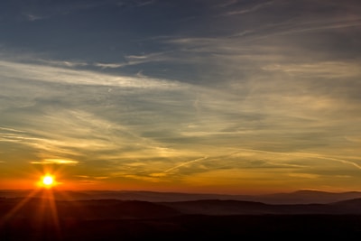 A scenic view of rolling hills at sunset.