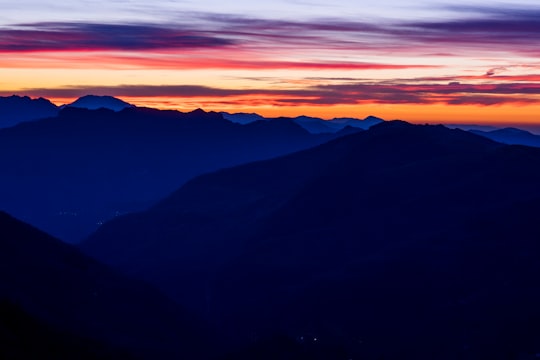 mountain ranges under orange sky during sunset in Monte Due Mani Italy