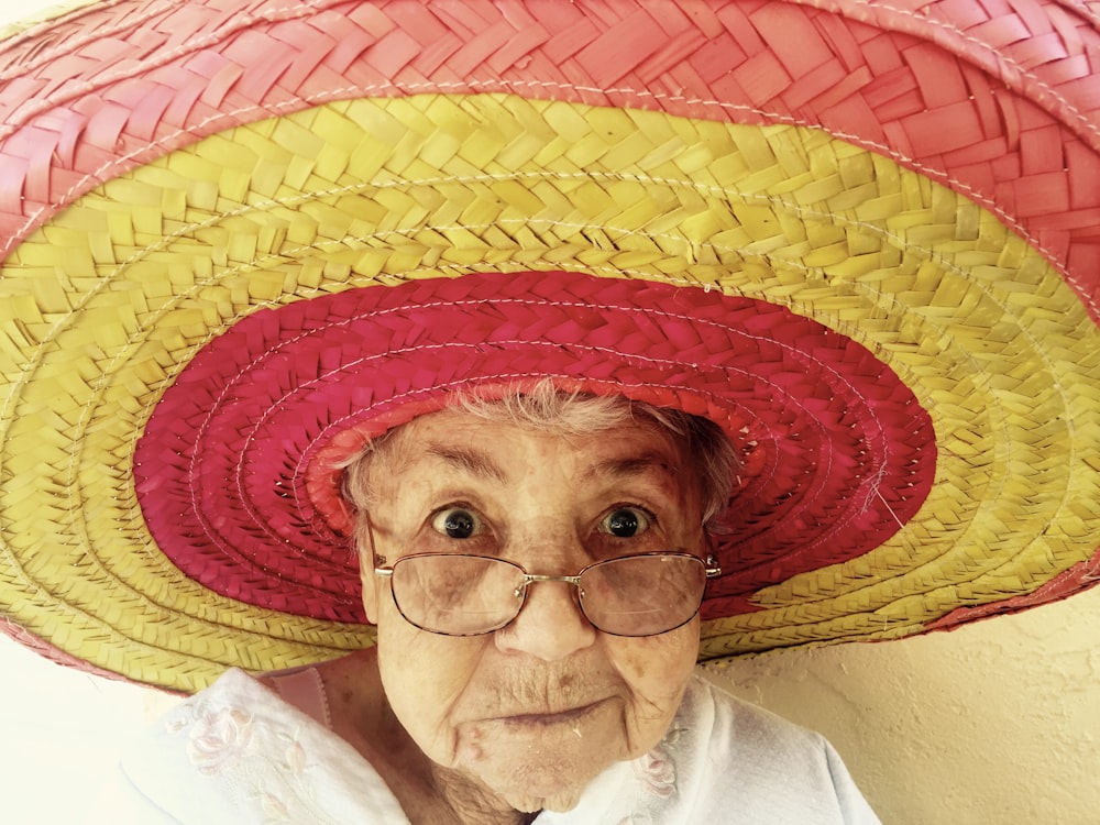 woman using eyeglasses and wearing hat