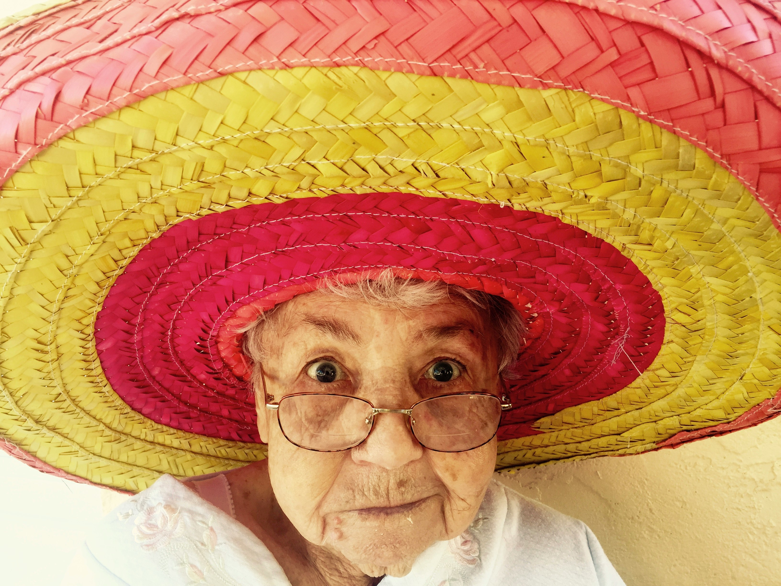 woman using eyeglasses and wearing hat