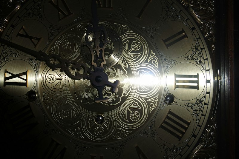 A brass-coloured antique analog clock mechanism, representing the geared astronomical clocks that appeared in Europe some fourteen centuries later