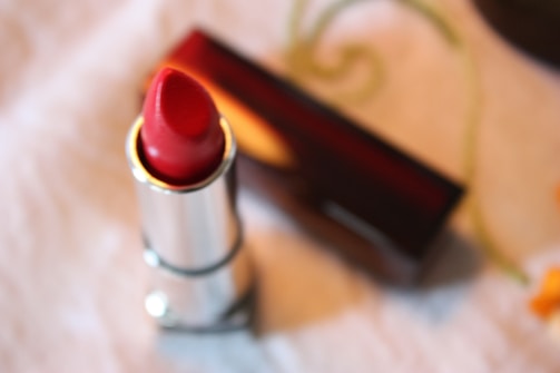 Close-up of a lipstick bullet revealing its rich color.