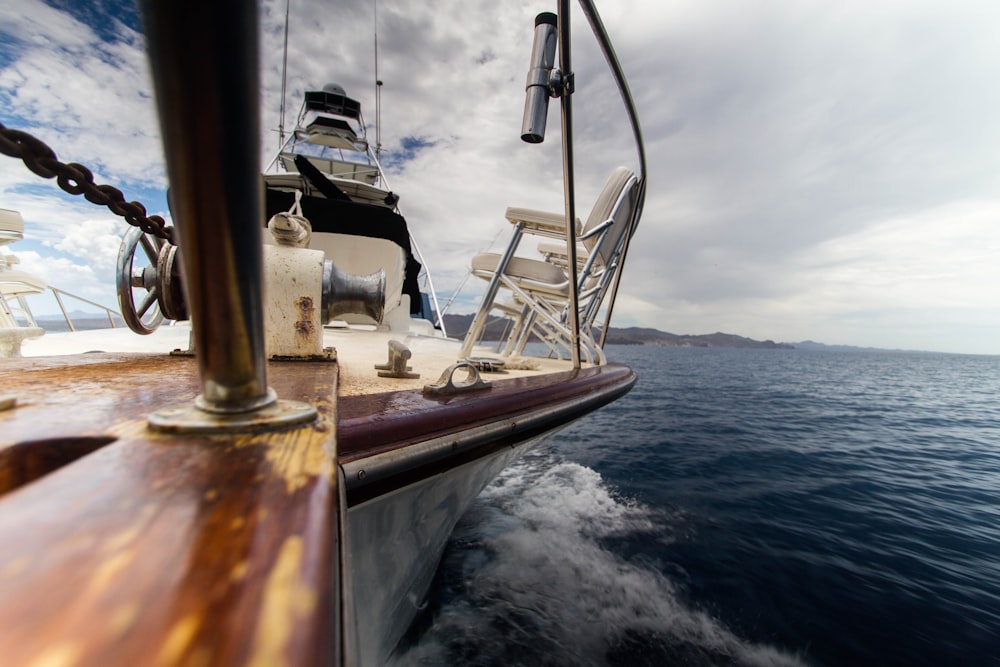 brown and white yacht on body of water