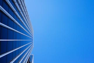 low-angle photography of curtain glass building under blue sky