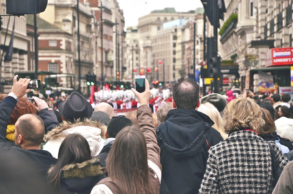 group of people in street watching parade