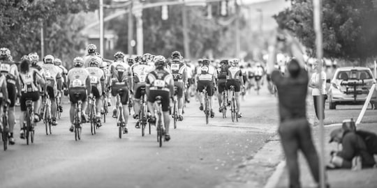 grayscale photo of cycler on the road in Logan United States