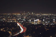 A lively cityscape at night with sparkling lights and busy streets.