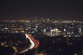 A lively cityscape at night with sparkling lights and busy streets.