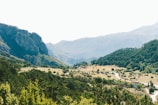 A scenic landscape featuring rolling hills and a winding road.