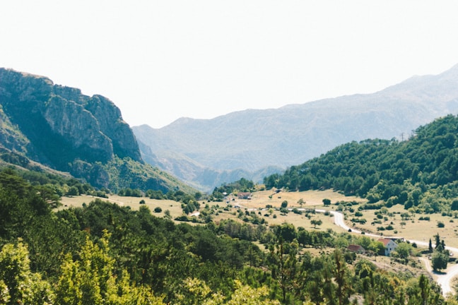 A scenic landscape featuring rolling hills and a winding road.