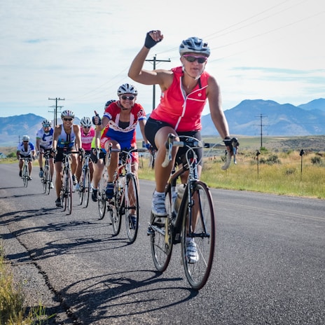 A group of cyclists smiling and sharing their Ride Like a Champ app results after a challenging trail ride.