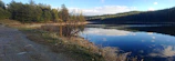 A peaceful meditation spot by a quiet lake surrounded by nature, evoking mindfulness.