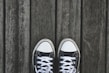 A pair of trendy sneakers on a wooden surface.