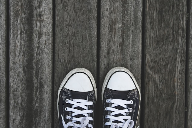 Close-up of casual sneakers on a wooden surface