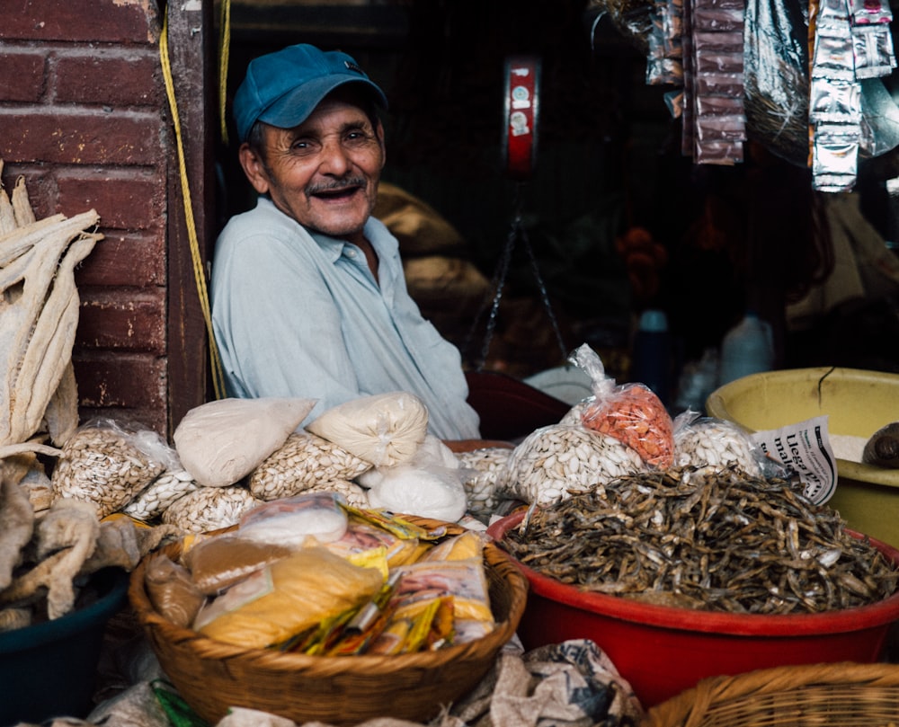 man in blue cap inside store