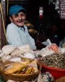 man in blue cap inside store