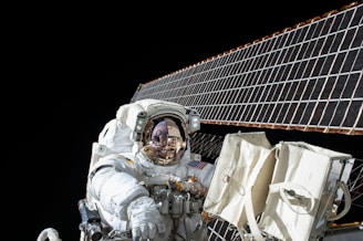 photography of Astronaut beside solar panel