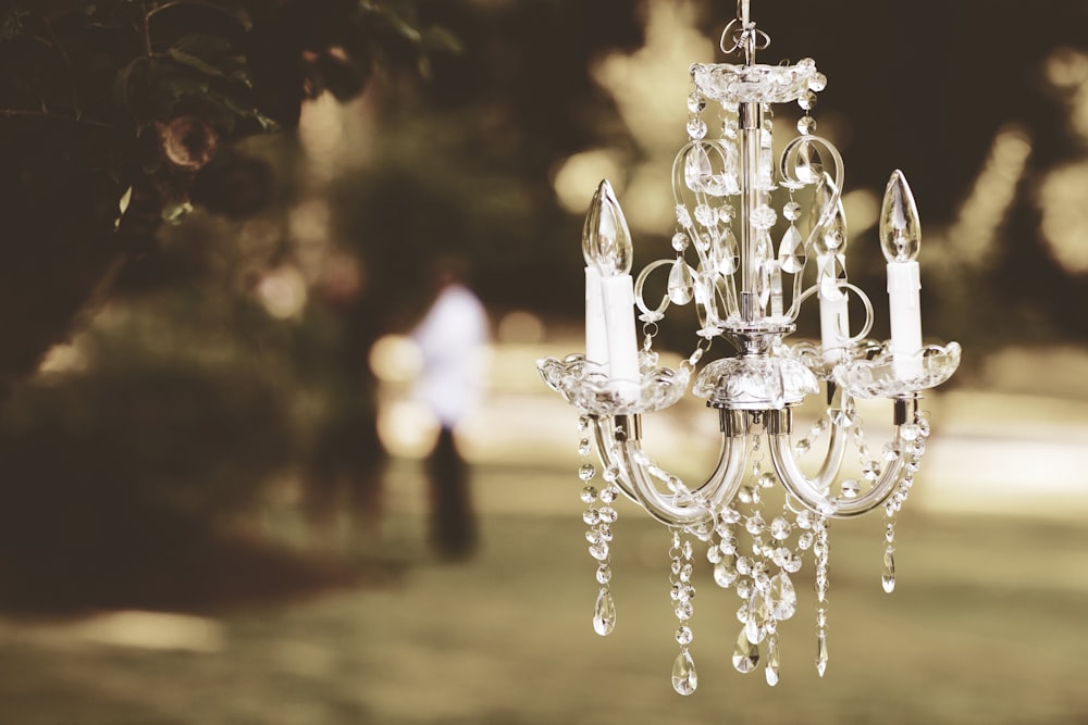 shallow focus photography of clear glass and silver chandelier