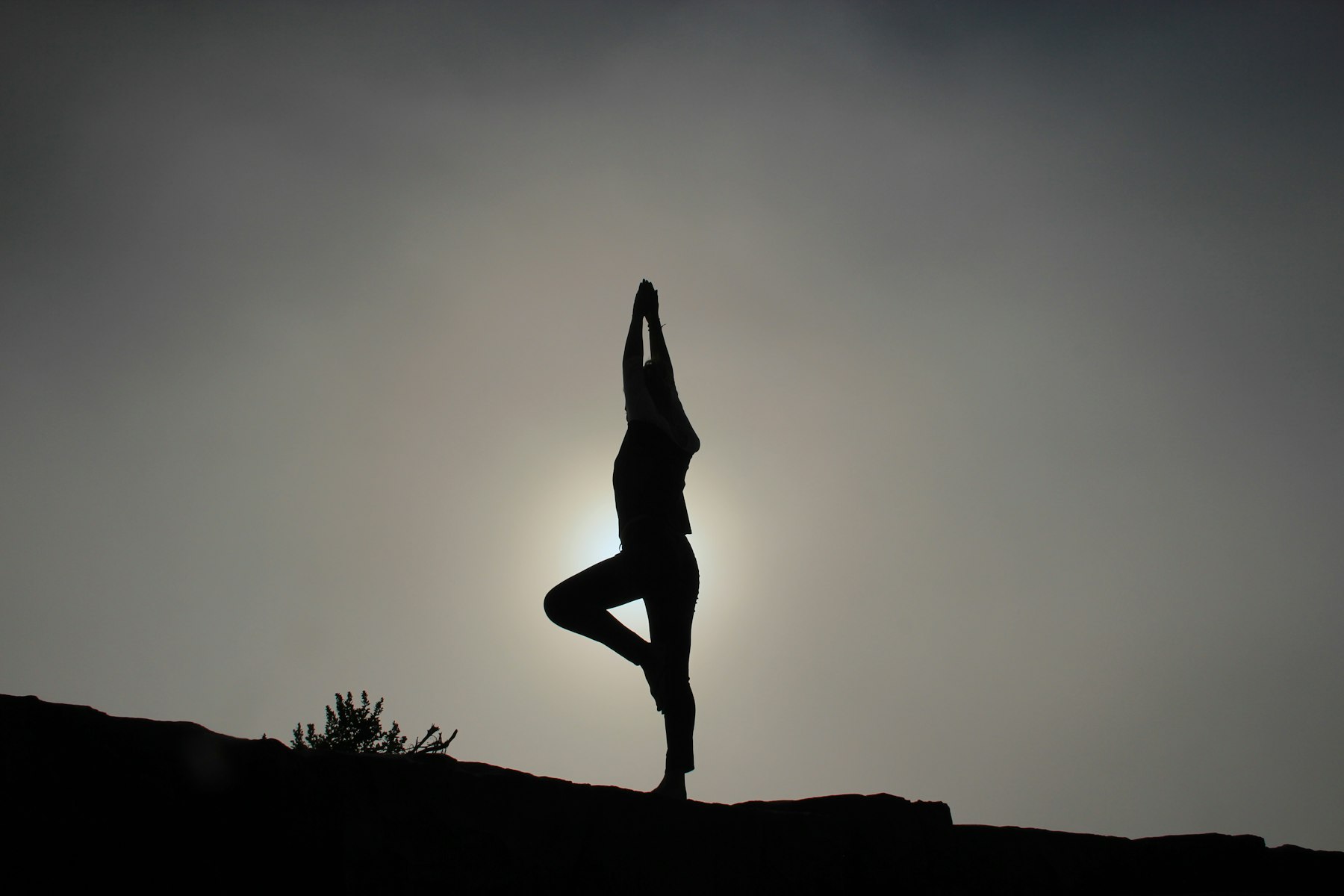 Person stretching outdoors at sunrise