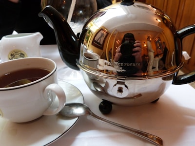 Artistic shot of an antique silver tea set reflecting subtle light.