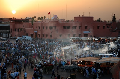 A group of happy travelers exploring a vibrant local market at sunset.