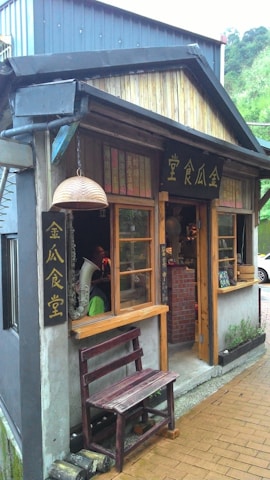 Cozy storefront of a handmade jewelry boutique with rustic wooden accents.