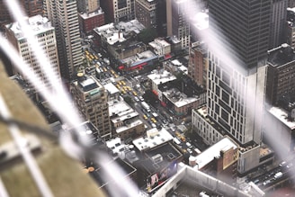 An aerial view of busy city streets filled with taxis.