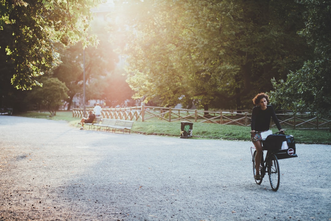 woman riding bicycle on park during daytime