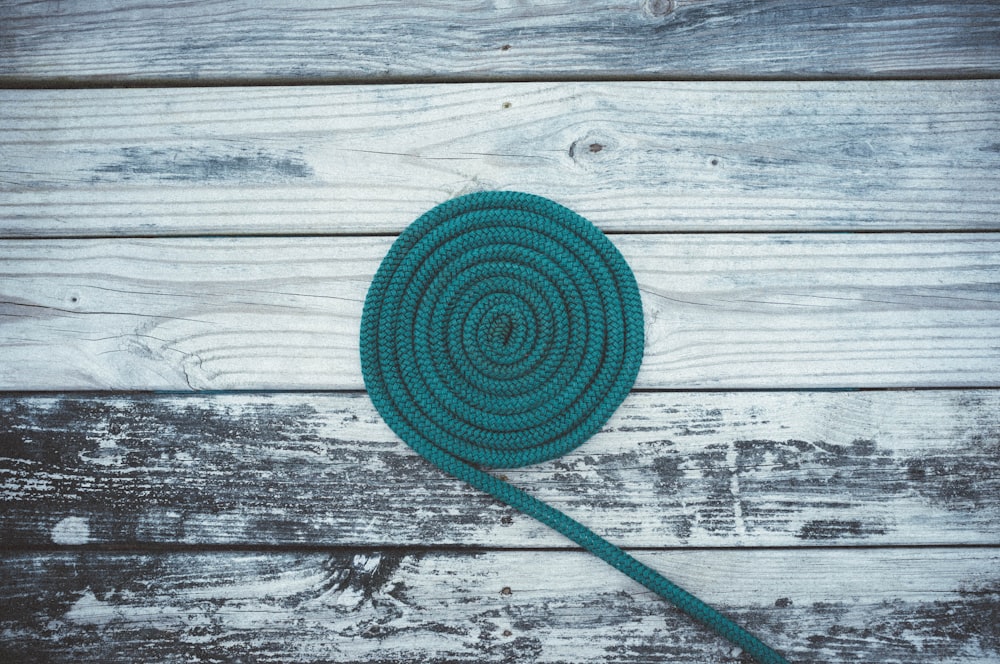 closeup photo of green coil on gray wooden board