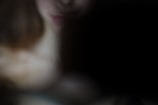 A mysterious figure partially obscured in darkness.
